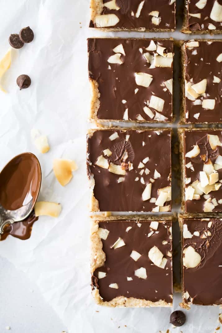 Top view of No Bake Almond Joy Bars topped with chocolate, almonds and coconut