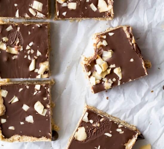 No Bake Almond Joy Bars a healthy dessert filled with coconut and almond butter then topped with chocolate for the ultimate bite. These healthy vegan bars are sure to satisfy your sweet tooth!