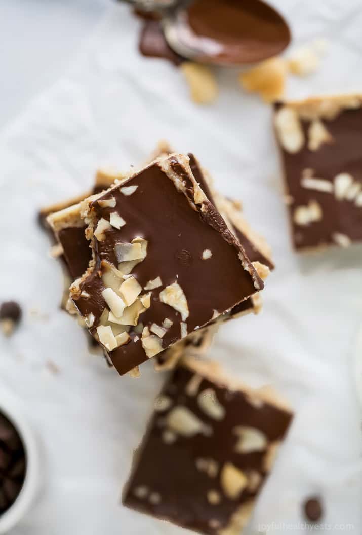 Top view of a stack of No Bake Almond Joy Bars topped with chocolate, almonds and coconut