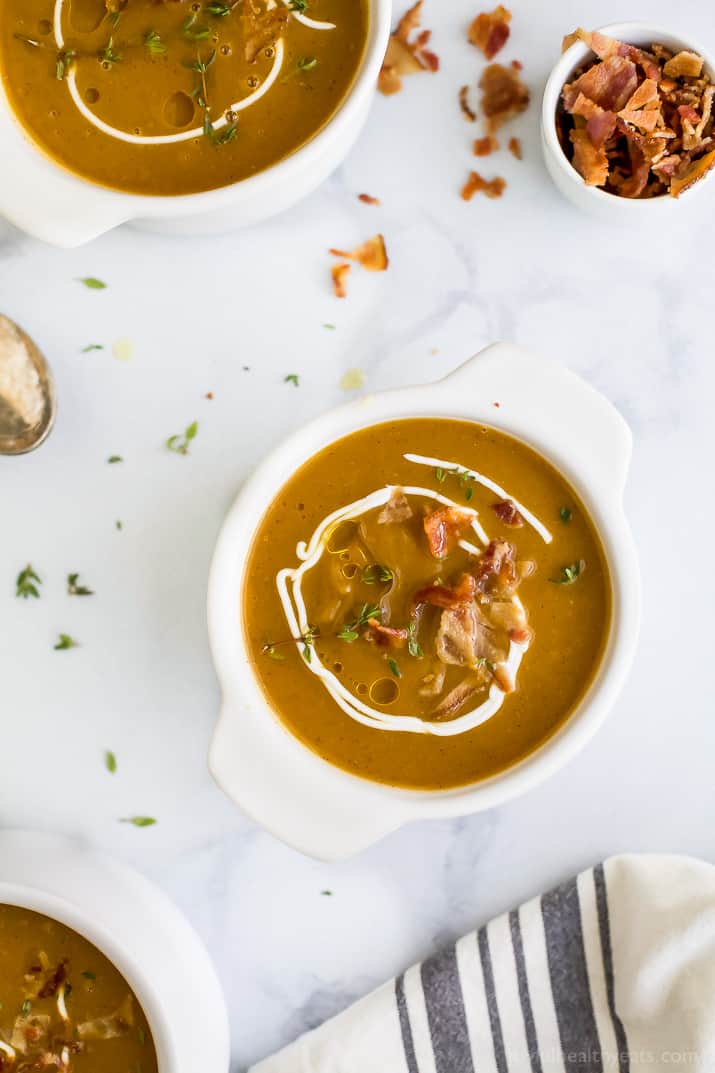 Paleo Instant Pot Autumn Squash Soup, filled with butternut squash, acorn squash, tummy warming spices and topped with bacon. An easy creamy squash soup that's guaranteed to be the star of the fall! #glutenfree