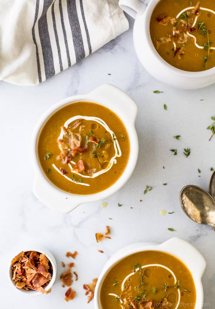 Paleo Instant Pot Autumn Squash Soup, filled with butternut squash, acorn squash, tummy warming spices and topped with bacon. An easy creamy squash soup that's guaranteed to be the star of the fall! #glutenfree