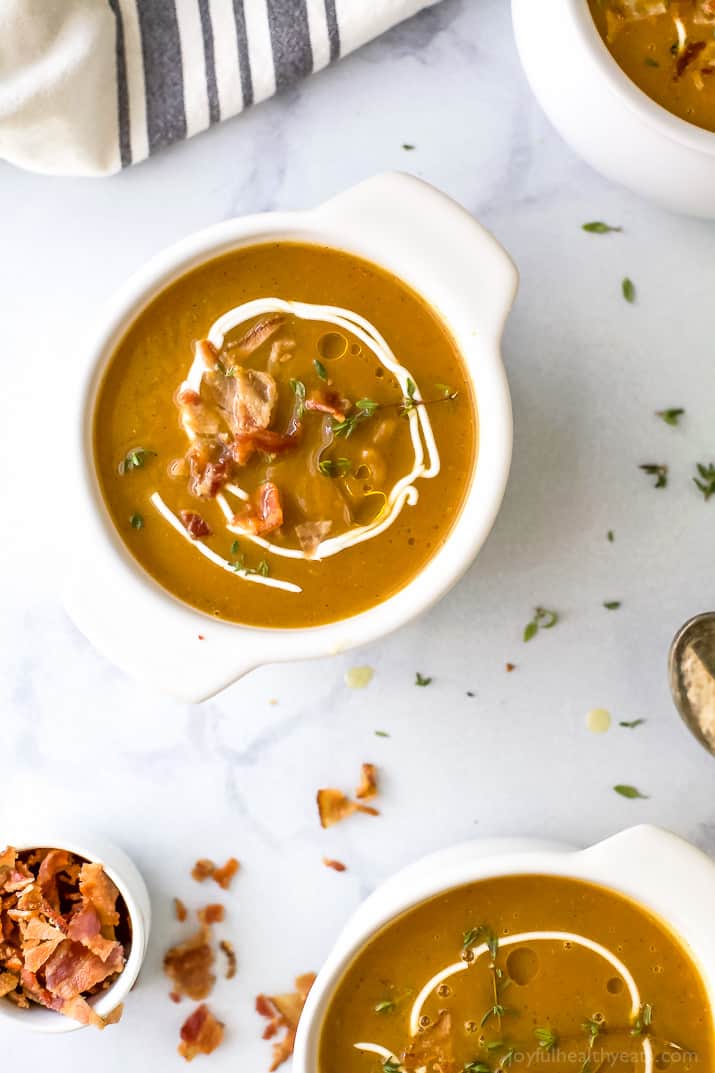 Paleo Instant Pot Autumn Squash Soup, filled with butternut squash, acorn squash, tummy warming spices and topped with bacon. An easy creamy squash soup that's guaranteed to be the star of the fall! #glutenfree