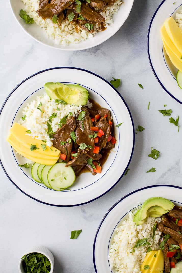 Top view of Instant Pot Korean Beef Bowl on a bed of cauliflower rice with mango and avocado