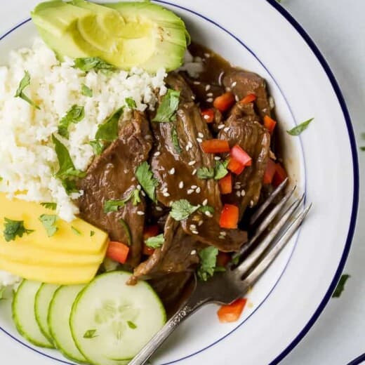 Overhead view of Korean beef bowls with cauliflower rice and veggies