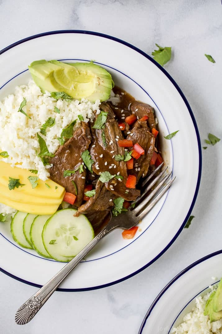 Top view of Instant Pot Korean Beef Bowl on a bed of cauliflower rice with mango and avocado