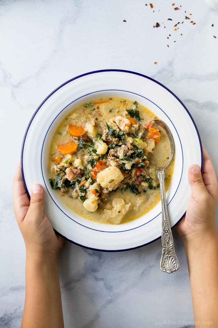 Instant Pot Zuppa Toscana Soup loaded with sausage, bacon, cauliflower and kale. This Zuppa Toscana recipe is low carb, dairy free, paleo and keto! It's an Olive Garden Copycat recipe that's guaranteed to be a hit!