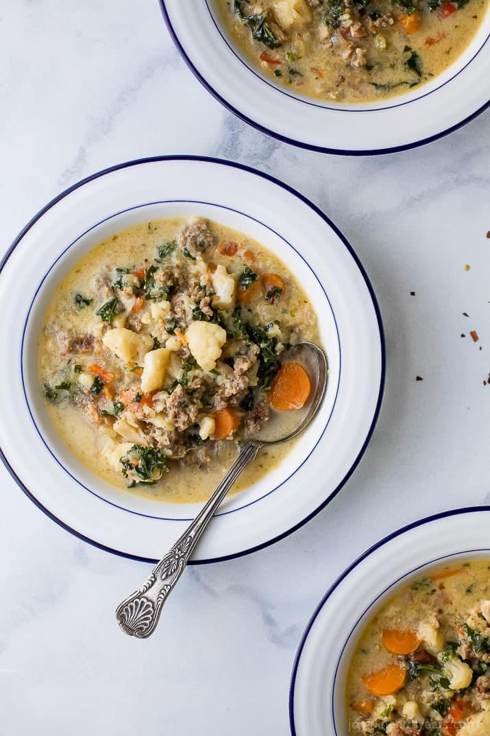 Instant Pot Zuppa Toscana Soup loaded with sausage, bacon, cauliflower and kale. This Zuppa Toscana recipe is low carb, dairy free, paleo and keto! It's an Olive Garden Copycat recipe that's guaranteed to be a hit!