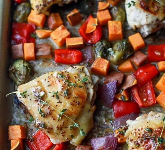 Oven Baked Honey Mustard Chicken Thighs with brussels sprouts and sweet potatoes. This Baked Chicken Thigh recipe is an easy one pan meal perfect for a quick healthy weeknight dinner. #paleo #glutenfree