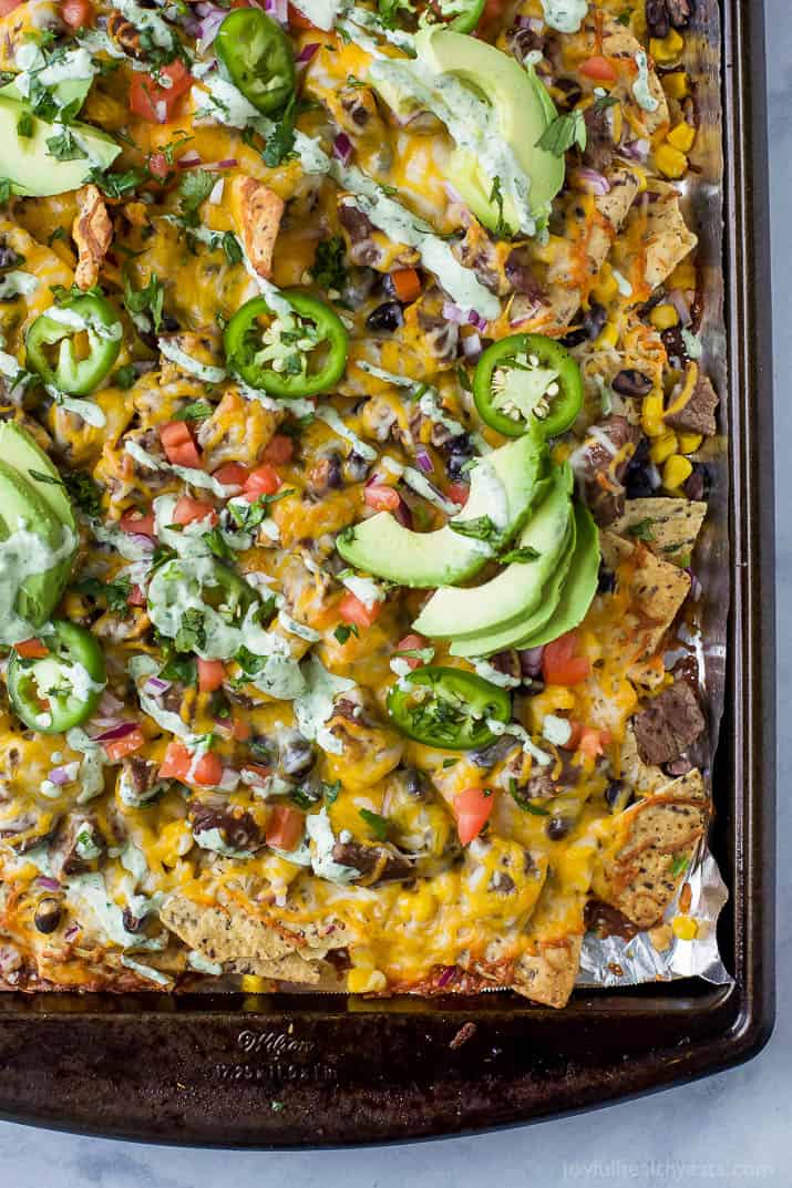 Steak nachos covered in cheese, crema and avocado.
