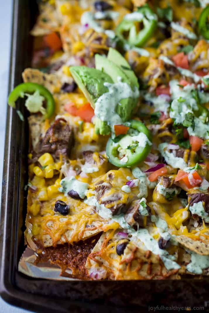 Loaded steak nachos covered in melted cheese.