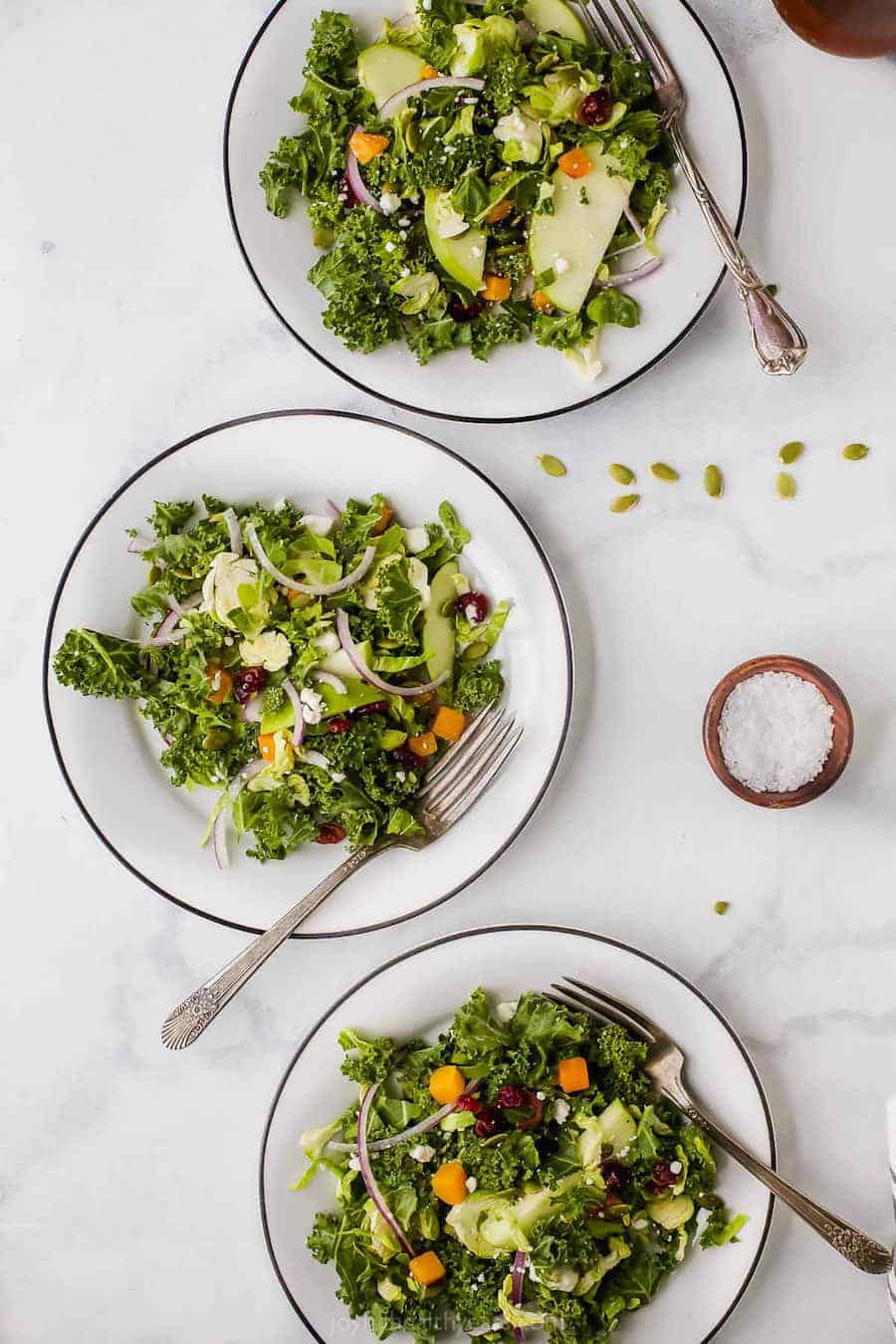 Top view of Healthy Cranberry Apple Brussel Sprout Salad in three bowls