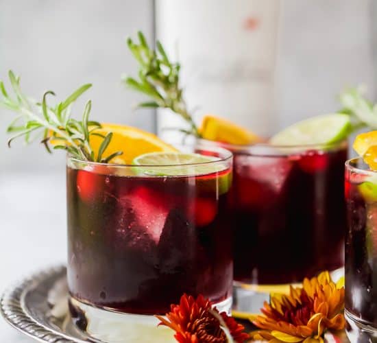photo of holiday cranberry sangria with rosemary in a glass