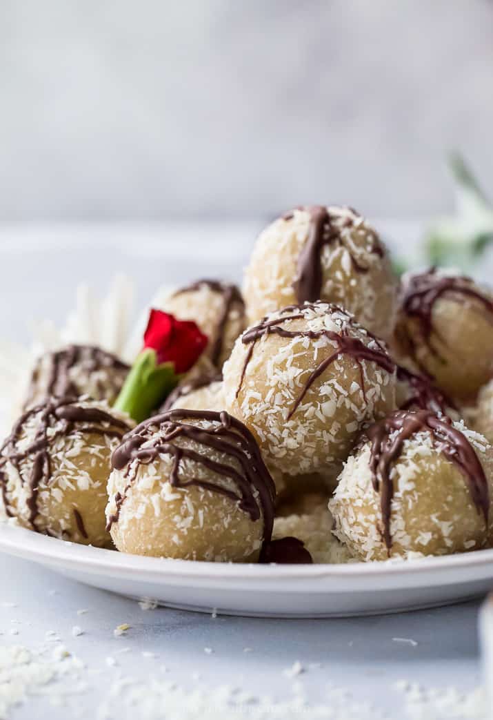 gluten free almond snowball cookies with chocolate drizzle on a plate