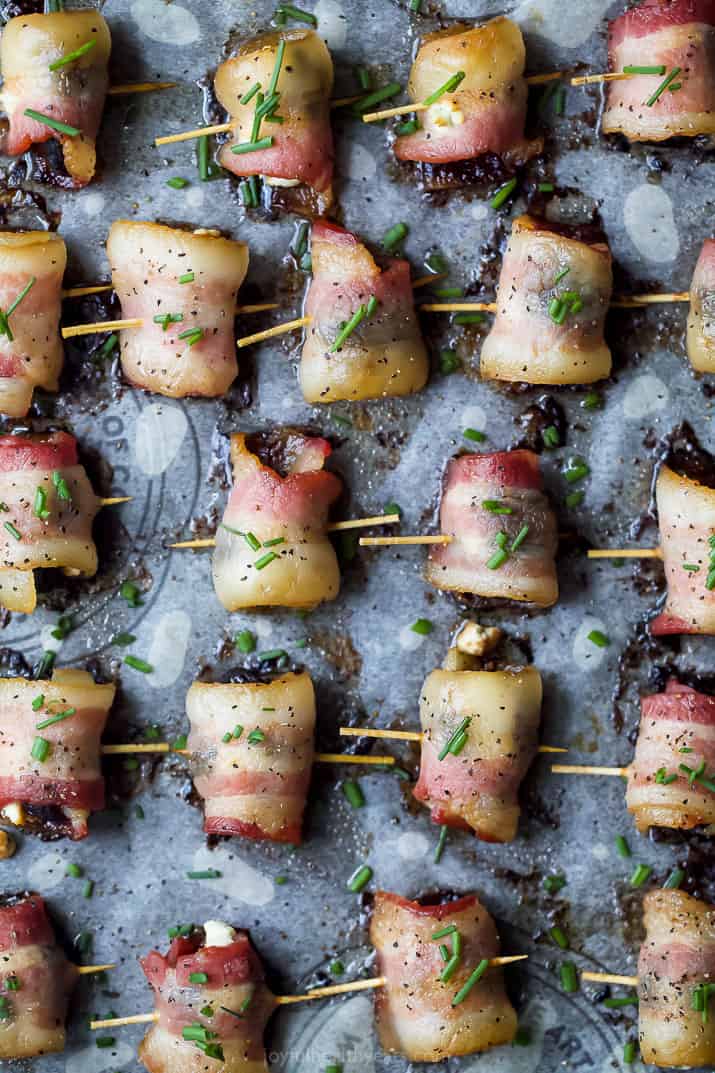 overhead photo of bacon wrapped figs with herb goat cheese on a baking sheet