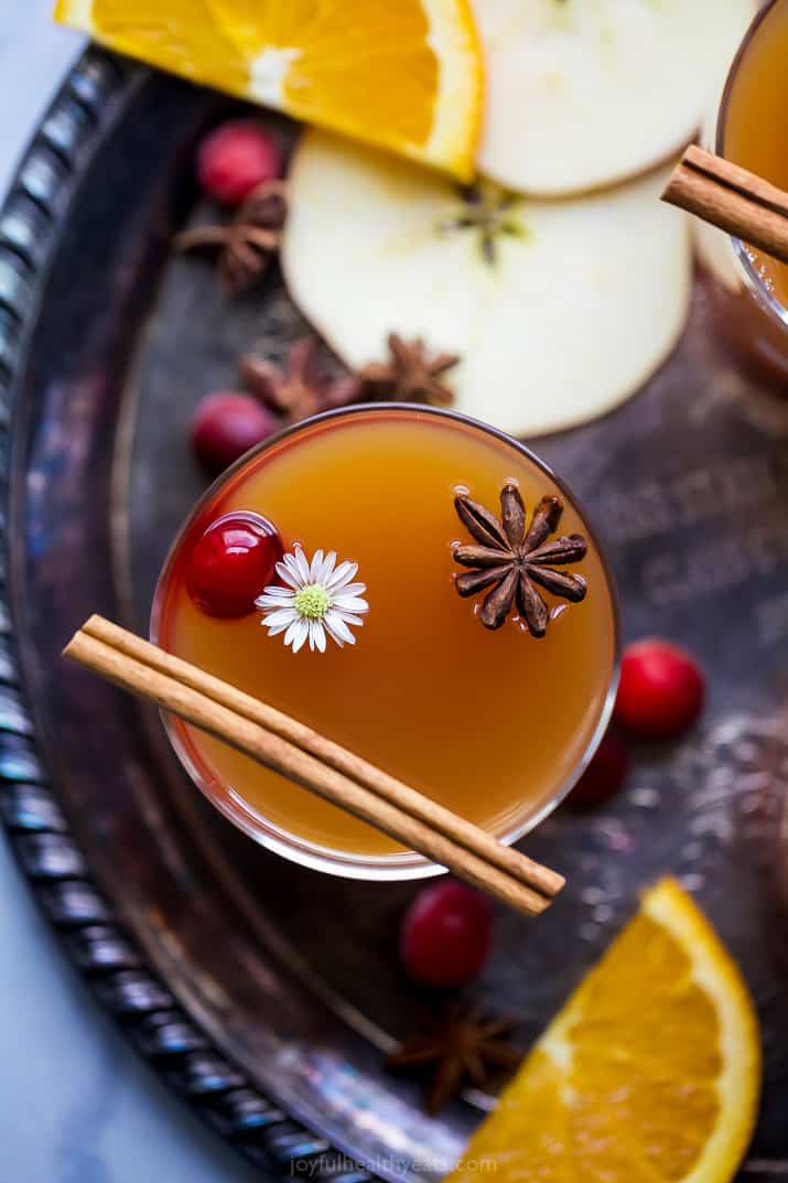 overhead view of hot spiked mulled apple cider in a cup with garnish