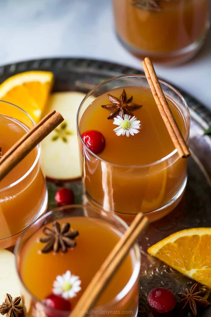 side view of hot spiked mulled apple cider recipe in cups