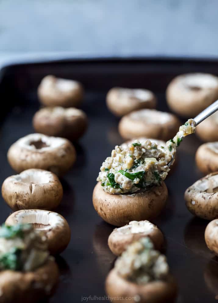 photo of mushrooms being stuffed with cheesy sausage mixture
