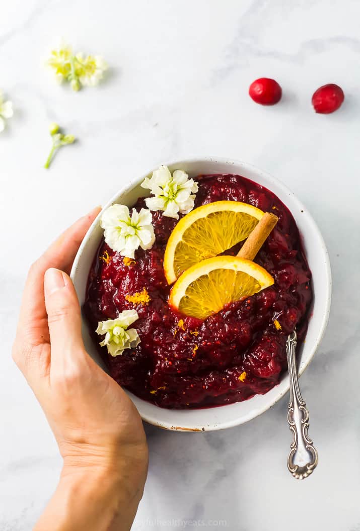 overhead photo of maple cranberry sauce with flowers on top