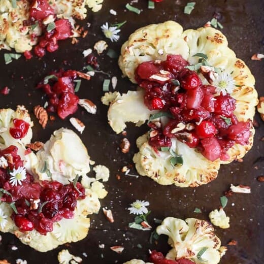 overhead photo of roasted cauliflower steaks with a cranberry apple chutney