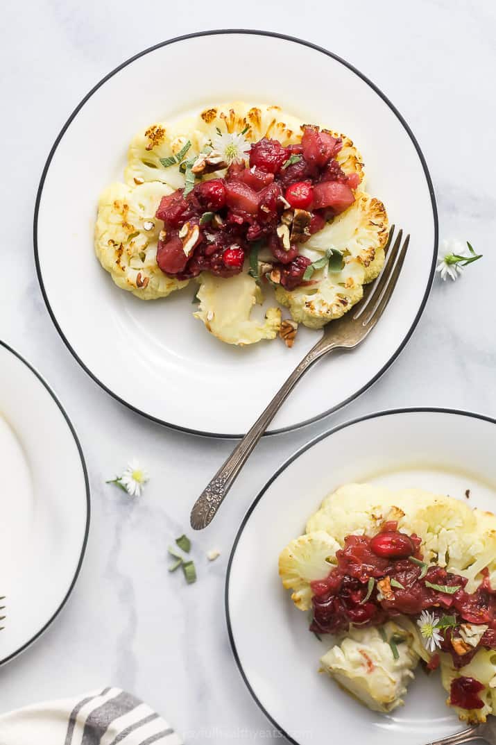 roasted cauliflower steaks with cranberry apple chutney on plates