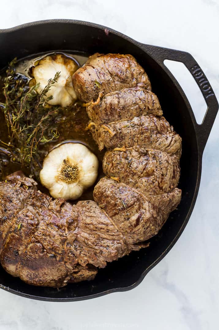 Roasted beef in the skillet with thyme and garlic. 