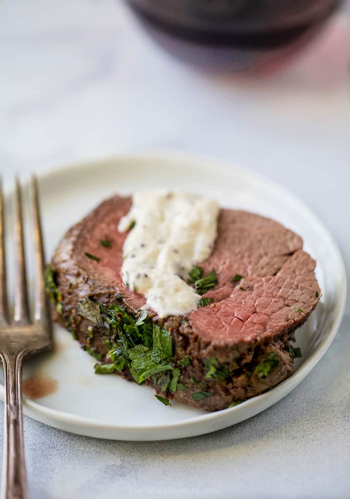 Tenderloin with herb crust and a drizzle of horseradish sauce on top. 