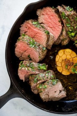 photo of beef tenderloin roast with a fresh herb crust in a cast iron skillet