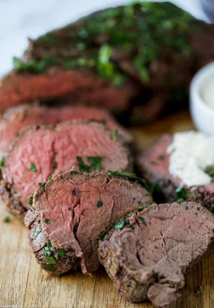 Close-up of sliced tenderloin on a cutting board. 