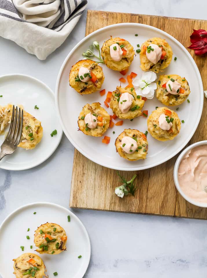photo of mini baked crab cakes with sriracha sauce on a plate 