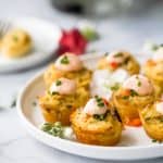 photo of mini baked crab cakes with sriracha sauce on a plate