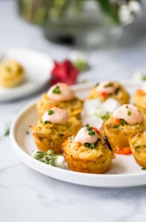 photo of mini baked crab cakes with sriracha sauce on a plate