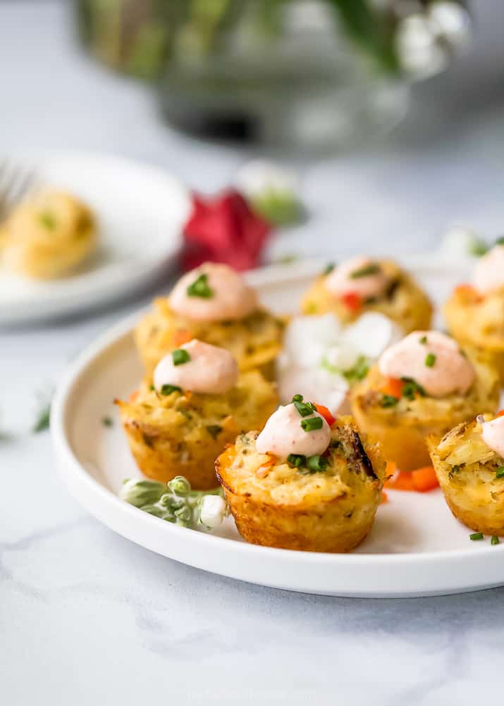 photo of mini baked crab cakes with sriracha sauce on a plate