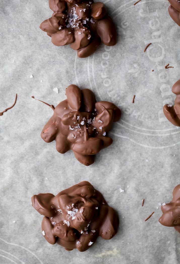 photo of chocolate toasted almond clusters drying on parchment paper