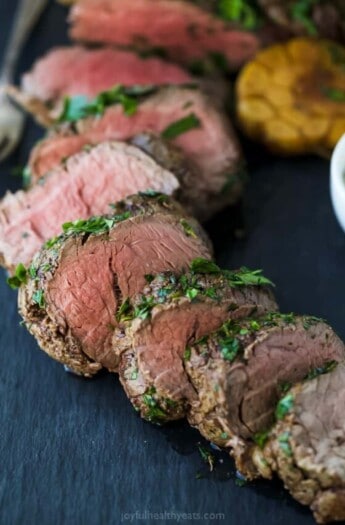 Sliced beef tenderloin with an herb crust.