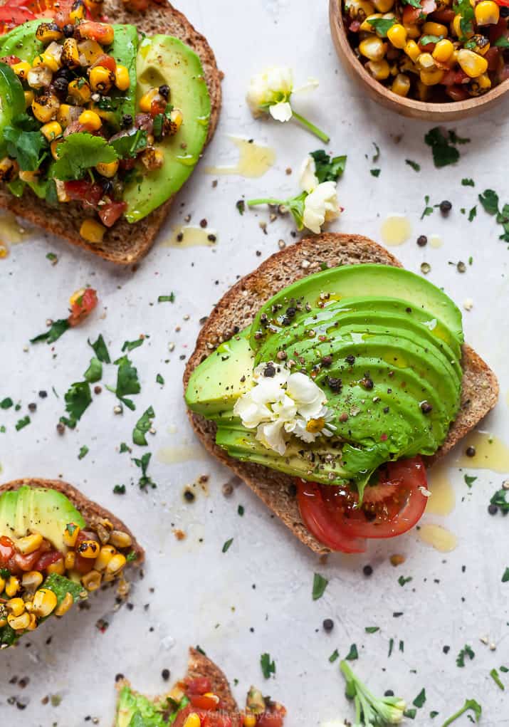 healthy avocado toast topped with charred corn salsa