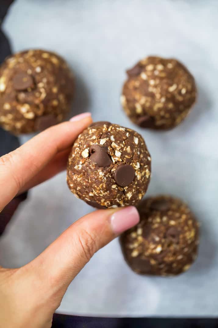 someone holding a chocolate brownie energy ball