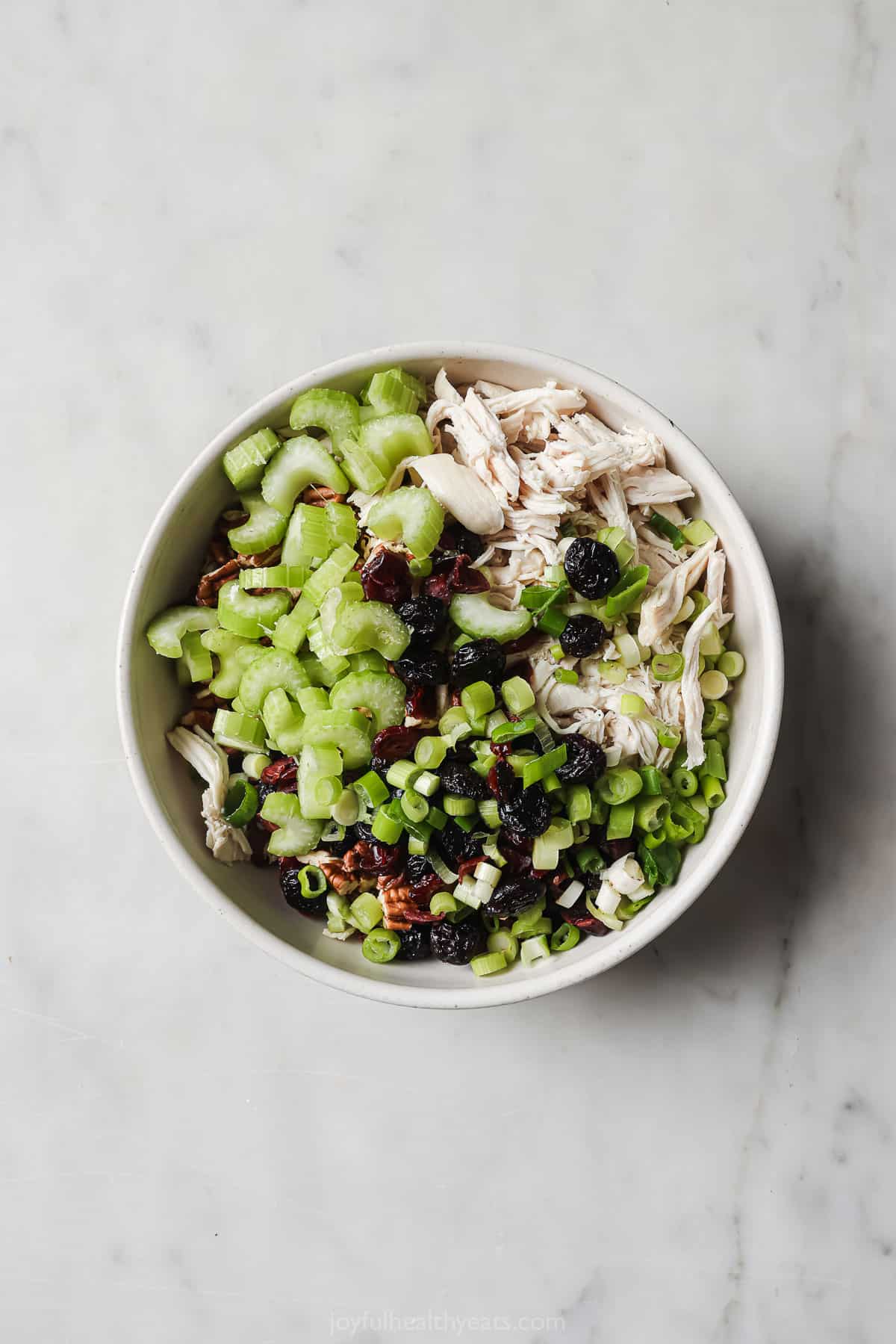 Salad ingredients and add-ins in a bowl.