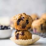 picture of healthy banana blueberry muffins piled on top of each other