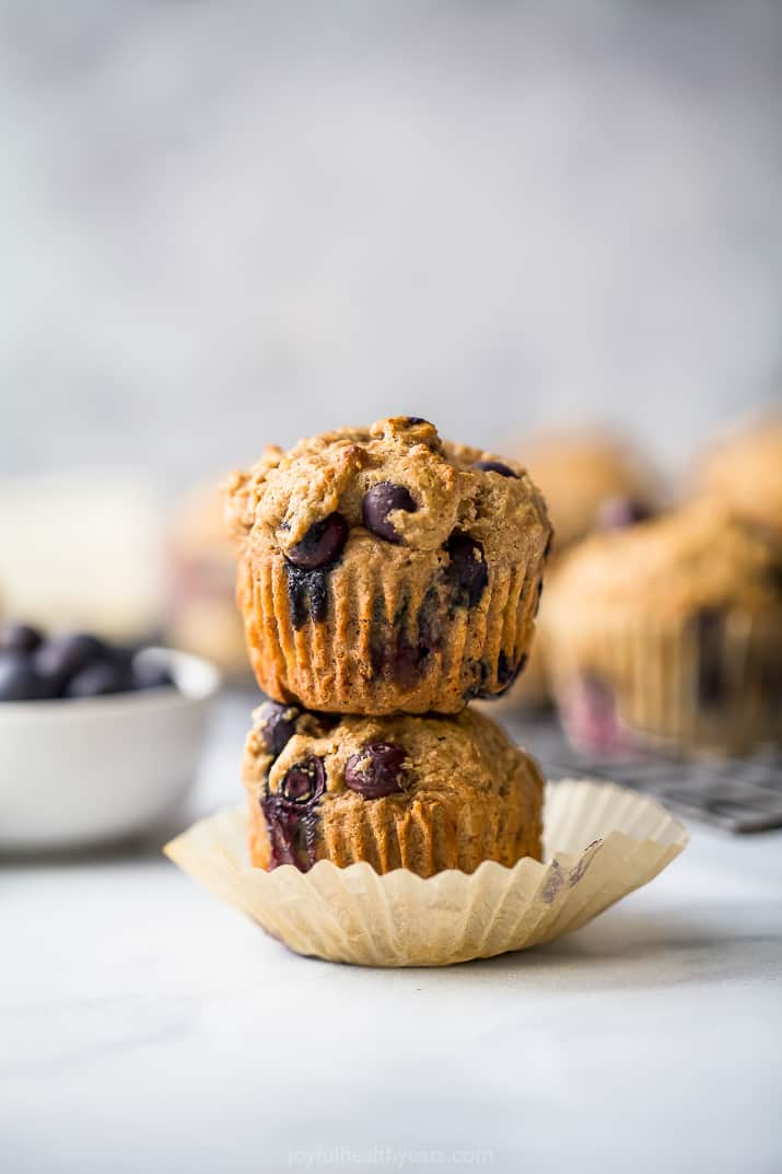 picture of healthy banana blueberry muffins piled on top of each other