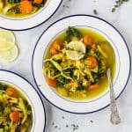 healing chicken soup recipe served in bowls topped with lemon