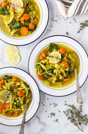 healing chicken soup recipe served in bowls topped with lemon