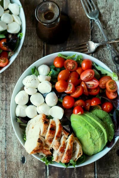 15 minute avocado caprese chicken salad with a balsamic dressing in a bowl