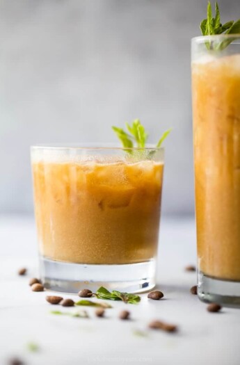 Small glass of Thai iced coffee set next to tall glass