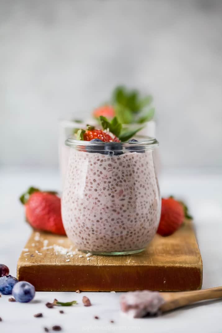 a jar filled with homemade strawberry chia pudding then topped with fruit