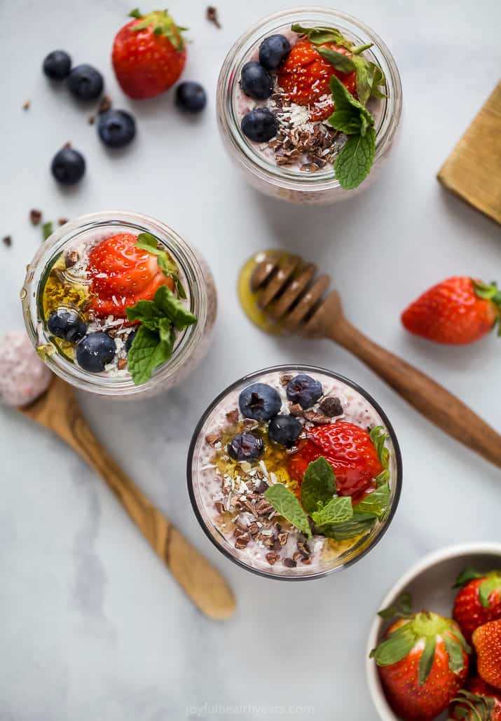 overhead photo of multiple jars filled with strawberry chia pudding