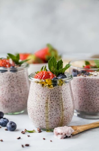 creamy strawberry chia pudding in a weck jar topped with fresh fruit