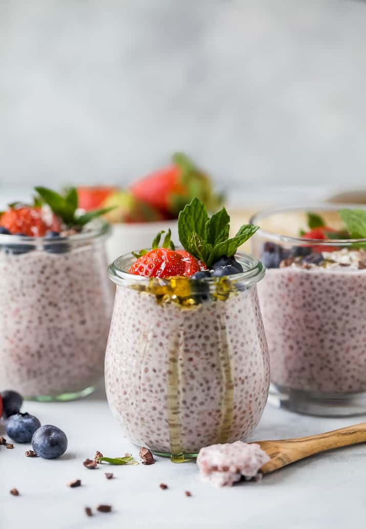 creamy strawberry chia pudding in a weck jar topped with fresh fruit