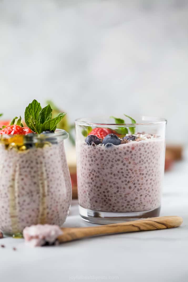 a jar filled with homemade strawberry chia pudding topped with fresh fruit