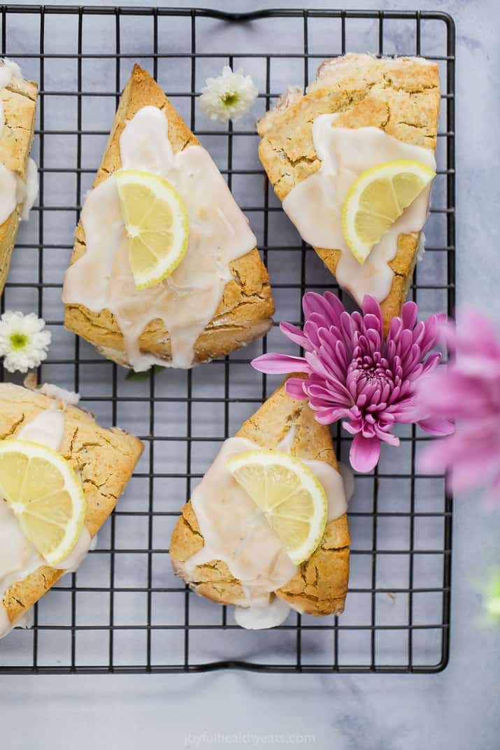 gluten free lemon poppy seed scones with a lemon glaze and lemon slice on top