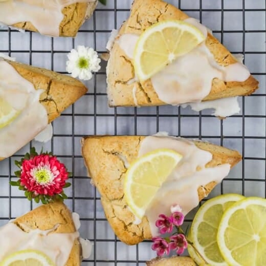gluten free lemon poppy seed scones with a lemon glaze and lemon slice on top